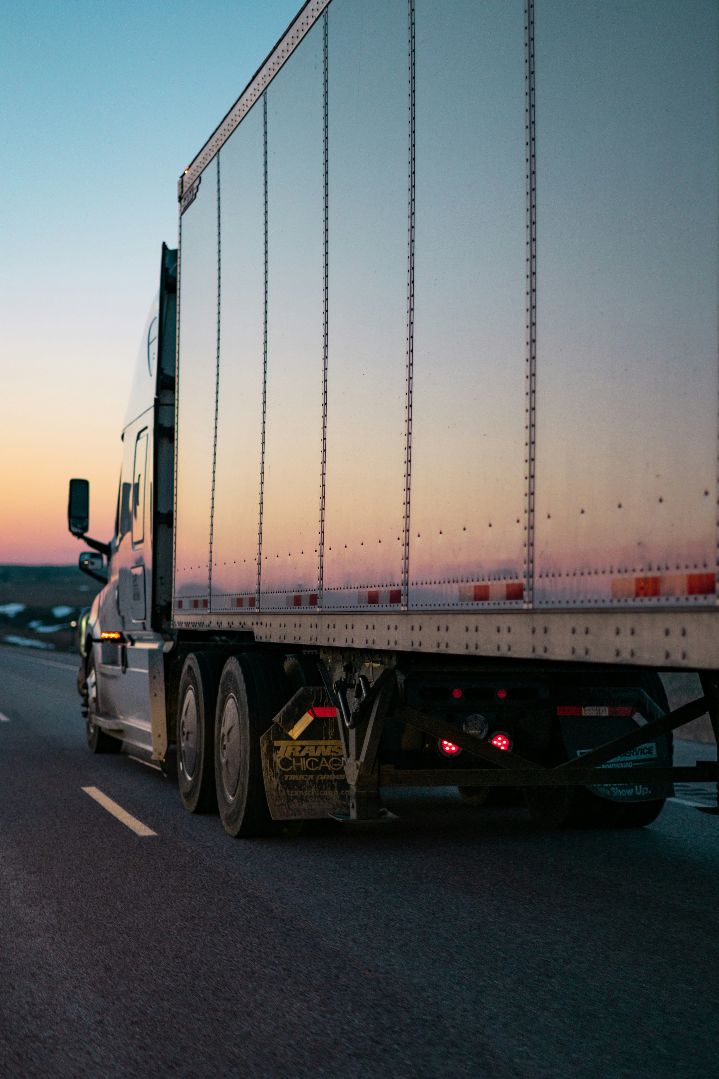 HGV Driver checking Drivano app in truck cab